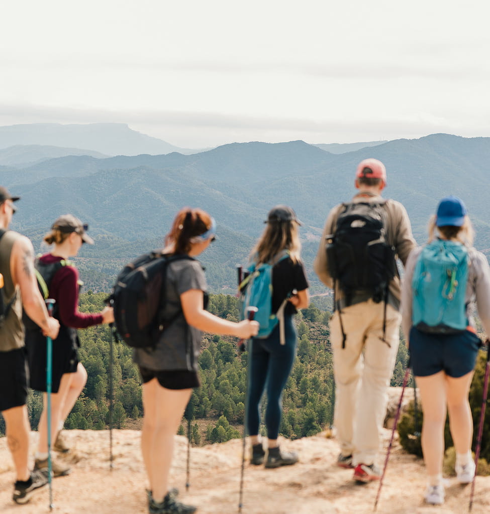 A group of people stood together looking out over a view of mountains