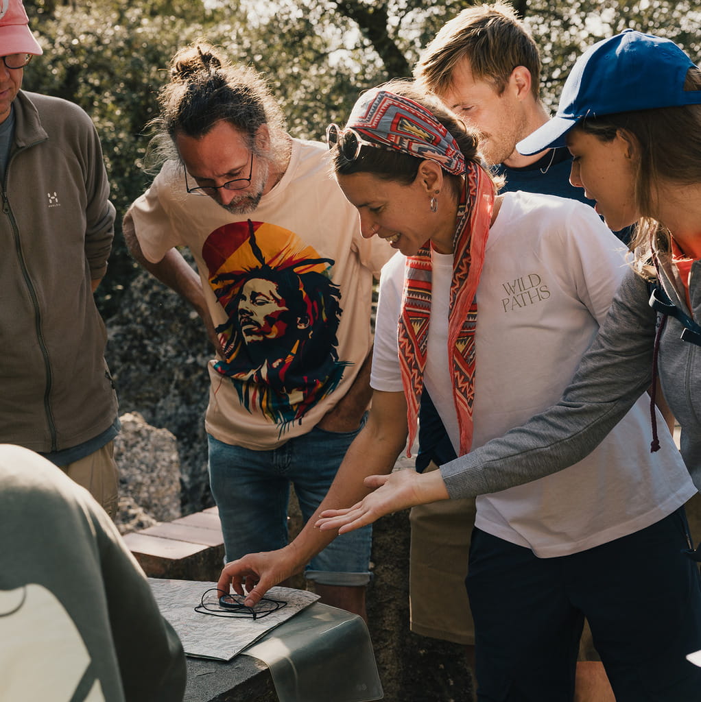 People gathered together looking at a map on a table