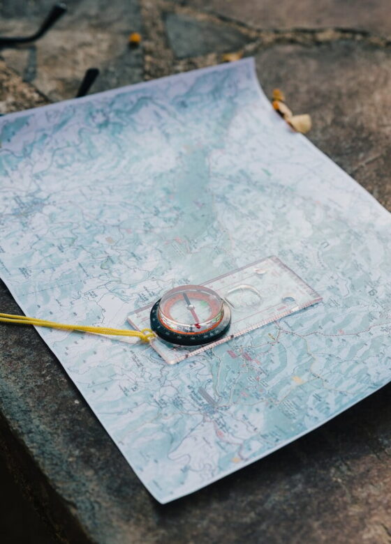 A compass is shown on top of a map